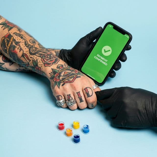 Client confirming a booking request in a tattoo studio