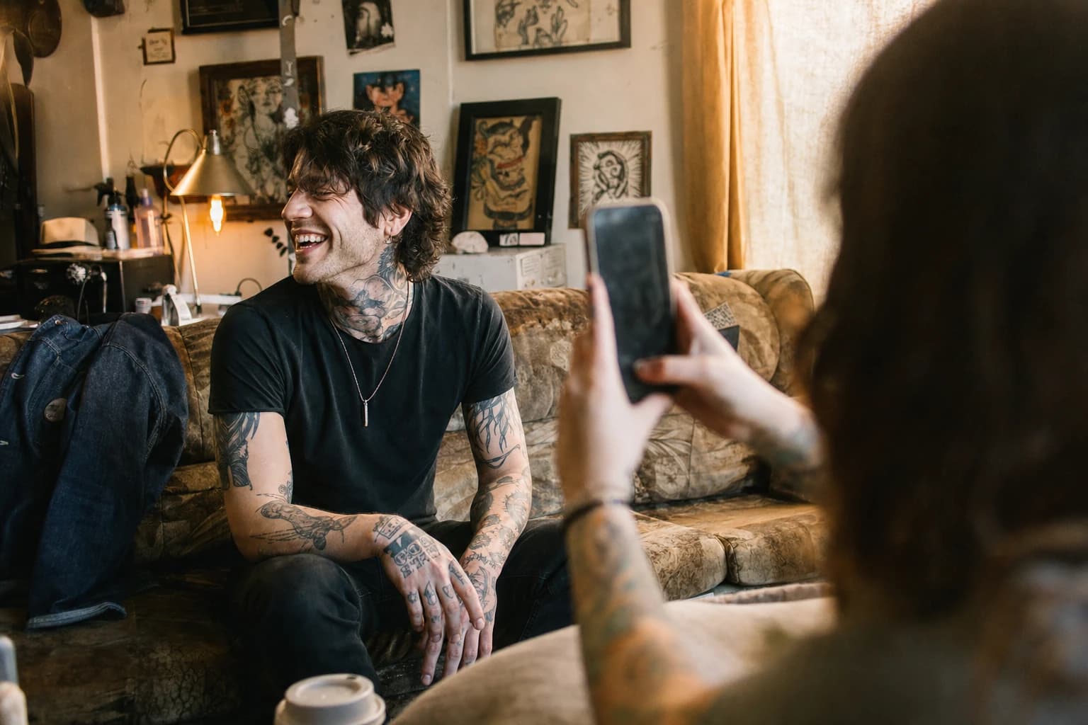 Candid client portrait in a lived-in tattoo studio